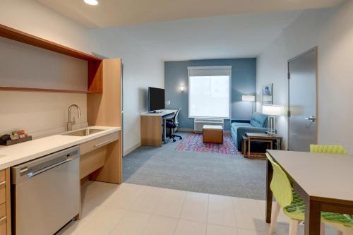 a room with a kitchen and a living room at Home2 Suites By Hilton Sanford in Sanford