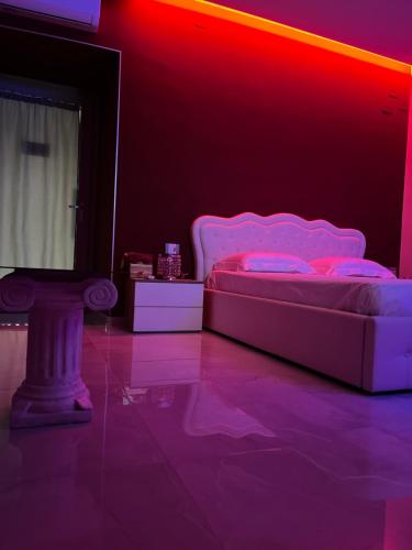 a bedroom with a bed with pink lights on it at Terraforte Luxury Suite in Fisciano