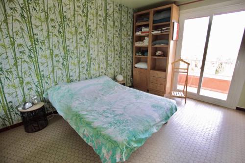 une chambre avec un lit et une porte coulissante en verre dans l'établissement 14454 Appartement 2 pièces à Mandelieu, à Mandelieu-la-Napoule