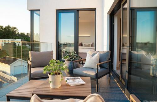 a patio with a table and chairs on a balcony at Villa Sund in Uddevalla