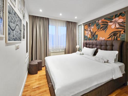 a bedroom with a large white bed in a room at Modern Harmony in Kolašin