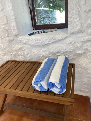 two blue and white towels sitting on a wooden bench at Casa de Sapiao & Studio in Afife