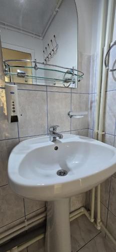 a white sink in a bathroom with a mirror at Casa Melcilor in Mangalia