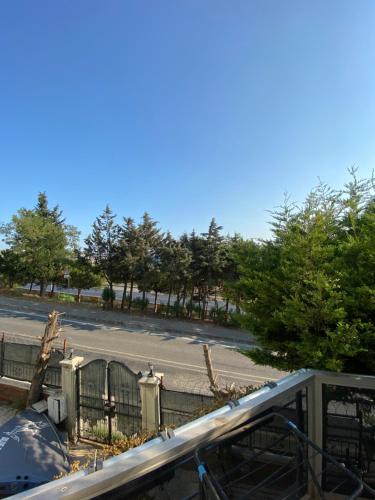 a view of a street with a fence and trees at Private villa suitable for families with stunning sea views in Buyukcekmece