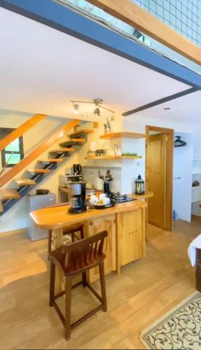 a kitchen with a wooden table and a staircase at Cozy corner in Ongata Rongai 