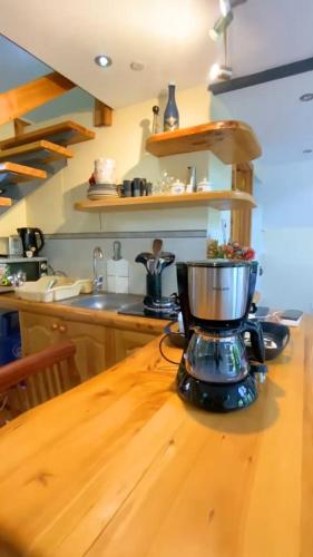 a kitchen counter with a blender on a wooden table at Cozy corner in Ongata Rongai 