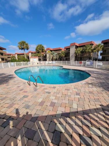 a small swimming pool in a brick courtyard at Inlet Point Villas 12E Cherry Grove Beach "The Point" in Myrtle Beach