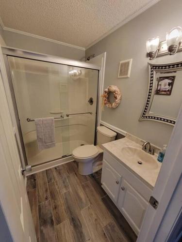 a bathroom with a shower and a toilet and a sink at Inlet Point Villas 12E Cherry Grove Beach "The Point" in Myrtle Beach