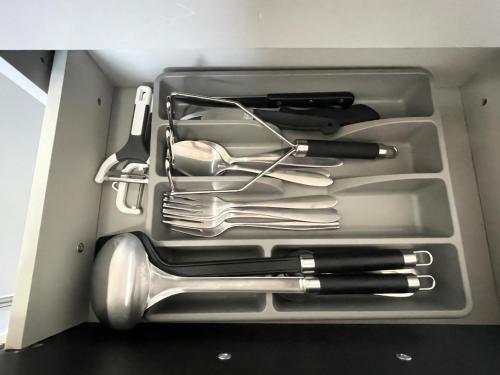 a drawer full of knives and utensils in a box at Fanta flat France Suisse in Saint-Louis