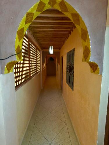 a hallway in a building with an archway at Hagounia hotel in Tan-Tan