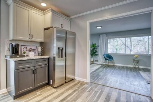 a kitchen with a stainless steel refrigerator and a window at Rocksteady Atlanta Decatur in Decatur