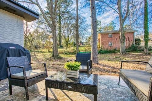 a patio with chairs and a table and a house at Rocksteady Atlanta Decatur in Decatur