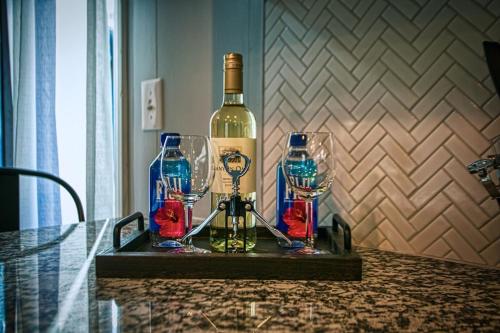 a bottle of wine and two wine glasses on a table at Rocksteady Atlanta Decatur in Decatur