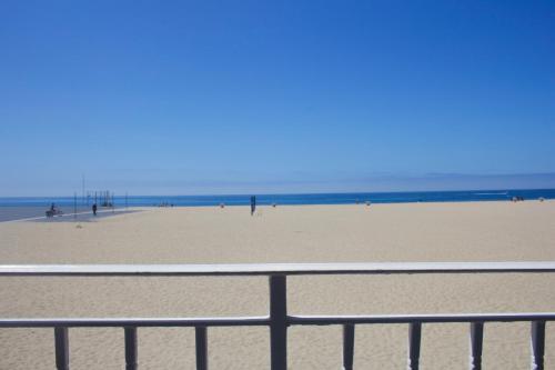 a view of a sandy beach with a fence at 1404 W Oceanfront B in Newport Beach