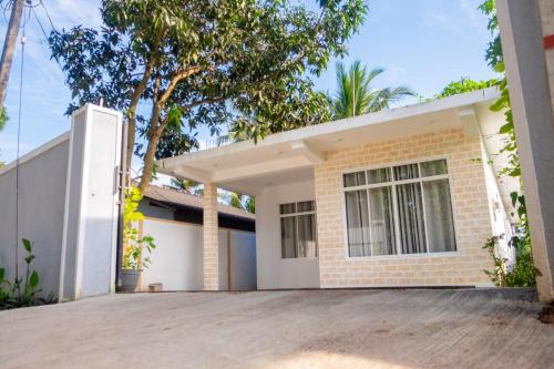 a house with a driveway in front of it at G A Villa Airport Transit Hotel in Katunayake
