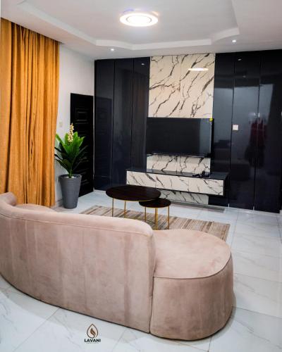 a living room with a couch and a table at Lavani Apartment in Benin City