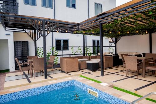 a patio with a pool and a table and chairs at Lavani Apartment in Benin City