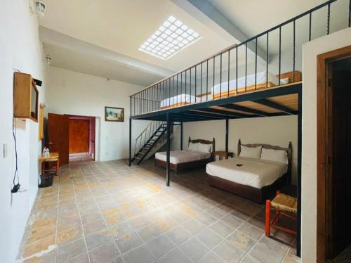 Ένα ή περισσότερα κρεβάτια σε δωμάτιο στο HOTEL EX HACIENDA EL MOLINO