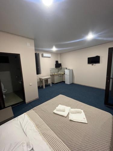 a room with a bed with two towels on it at Simple studio in K'obulet'i