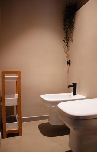 a bathroom with a white sink and a toilet at San Michele in Turi