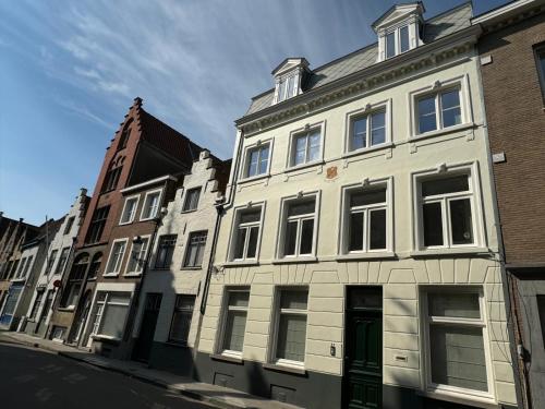 a row of buildings on a city street at Brouwerij De Sleutels in Bruges