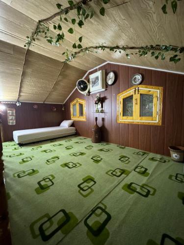a room with a bed and a green carpet at Hidden Resort Abbottabad in Abbottabad