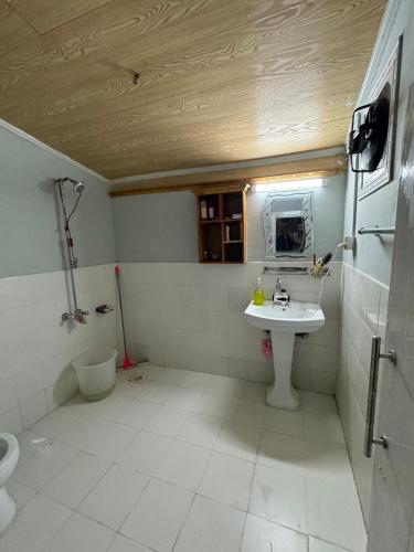 a bathroom with a sink and a mirror in it at Hidden Resort Abbottabad in Abbottabad