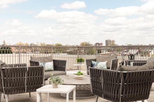 a patio with chairs and tables on a roof at Archer Hotel Old Town Alexandria in Alexandria