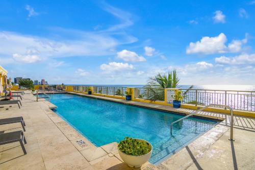 a swimming pool with the ocean in the background at The Atlantic Hotel & Spa in Fort Lauderdale