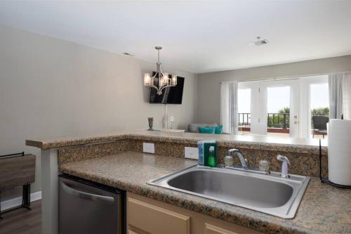 a kitchen counter with a sink and a window at Oceanfront Resort! at Ocean Delight! in North Topsail Beach