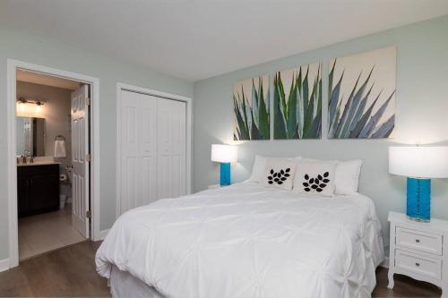 a bedroom with a large white bed with two lamps at Oceanfront Resort! at Ocean Delight! in North Topsail Beach