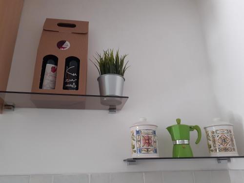 a shelf with a plant and a coffee pot on it at Luledielli in Montecilfone