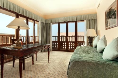 a hotel room with a bed and a desk at Cairo World Trade Center Hotel & Residences in Cairo