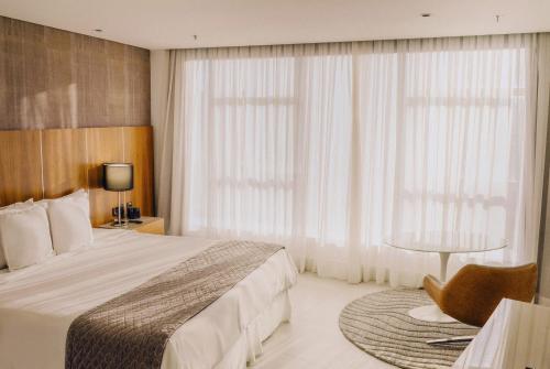 a hotel room with a bed and a window at Hotel Nacional Rio de Janeiro - OFICIAL in Rio de Janeiro