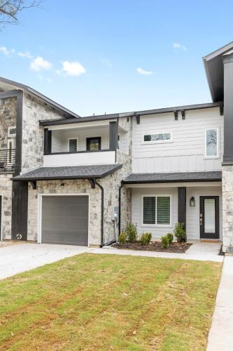 a house with a garage and a grass yard at Lone Star Escape in Arlington