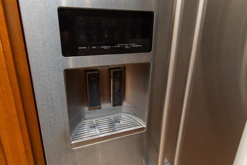 a metal refrigerator with an open door with at Amethyst Hearth - Family Spa Serenity, Zoo, Beach, Disneyland, Legoland in Vista
