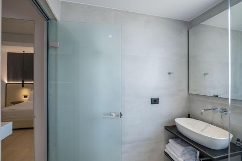 a bathroom with a sink and a shower at Arrei Hotel in Sarandë