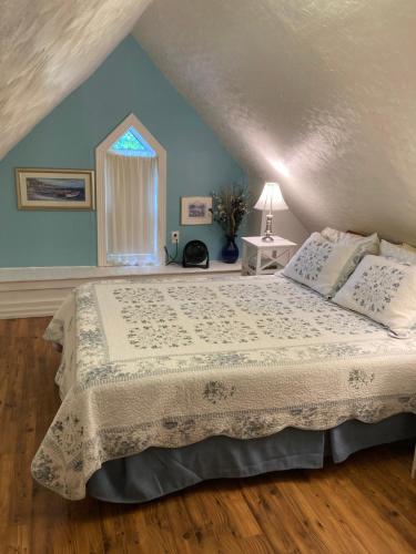 a bedroom with a bed and a window at West Gate Bed and Breakfast in Gananoque