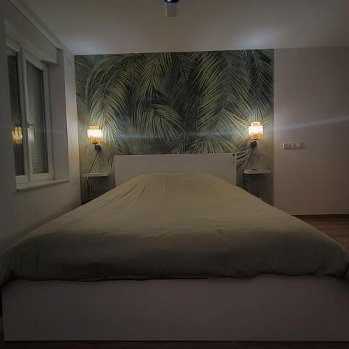 a bedroom with a large bed with a wall mural at L'Escale Châtillonnaise - L'Explorateur in Châtillon-sur-Loire