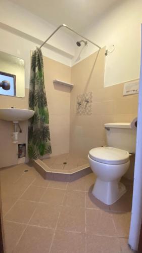 a bathroom with a toilet and a shower at La Pascana Hospedaje in Cajamarca
