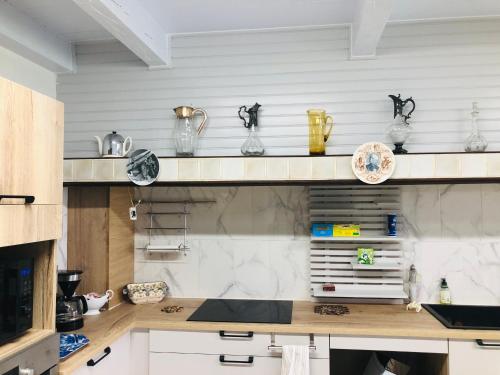 a kitchen with a counter with vases on shelves at Casa Scaglione in Porticcio