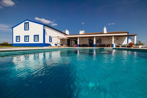 a house with a swimming pool in front of it at Monte do Melo in Montemor-o-Novo