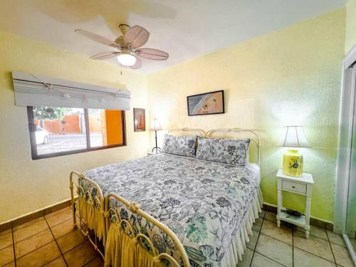 a bedroom with a bed and a ceiling fan at Sandy Beach Princesa D107 Ocean Front Resort in Puerto Peñasco