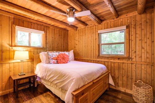 a bedroom with a bed in a wooden cabin at Lakefront Lusby Home with Fire Pit 3 Mi to Beach! in Lusby