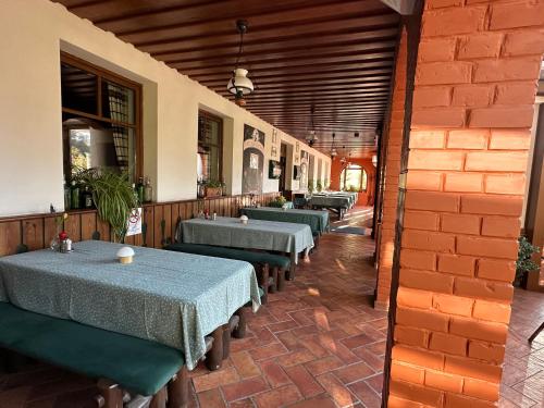 a row of tables in a restaurant with blue table cloth at Kígyósi Csárda & Panzió in Fülöpszállás