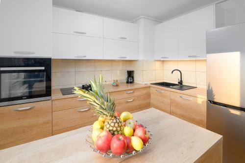 a bowl of fruit on a table in a kitchen at Čarobni pogled Zagreb in Zagreb