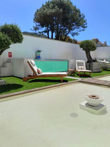 a patio with two lounge chairs and a pool table at Casa de Moledo Beach, Spa & Sauna in Moledo