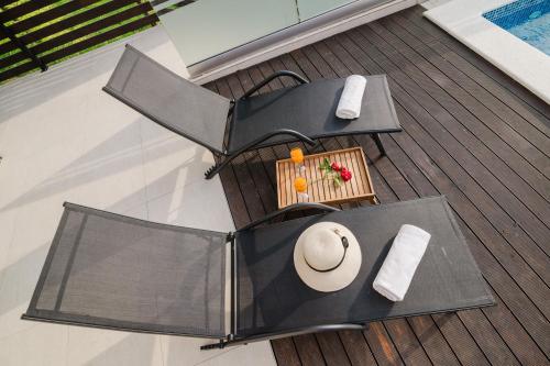 an outdoor table and chairs on a deck at Čarobni pogled Zagreb in Zagreb