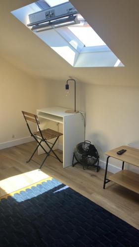 a living room with a table and a skylight at Sintra Flower Vintage Chalet in Sintra