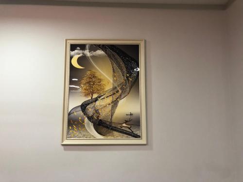 a picture of a tree in a picture frame on a wall at Suite In City Center in Tirana